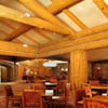 dead standing spruce logs built into dining room